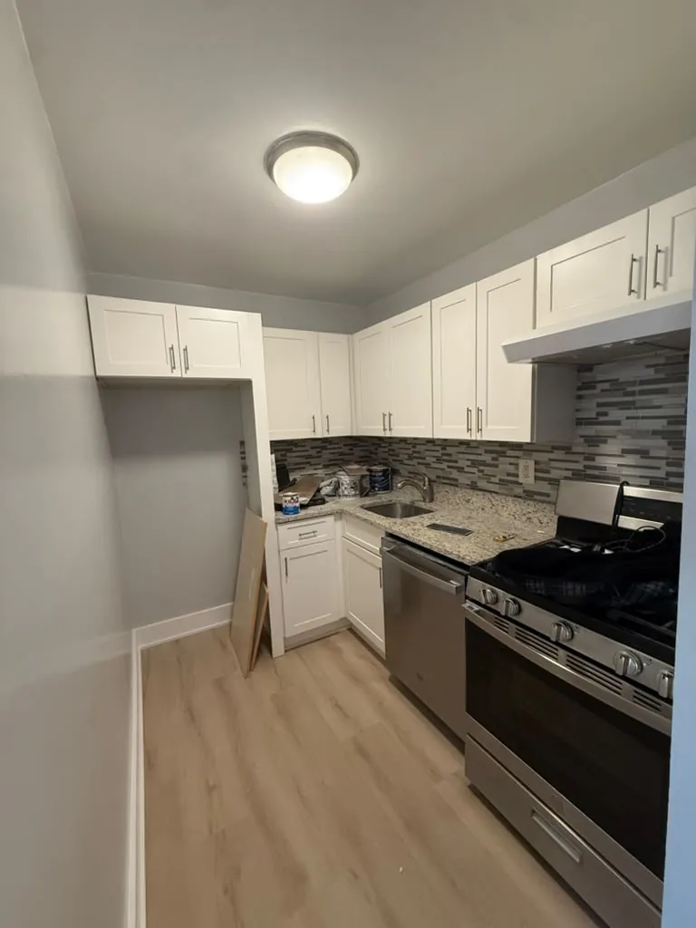 Modern kitchen with white cabinets and tile backsplash